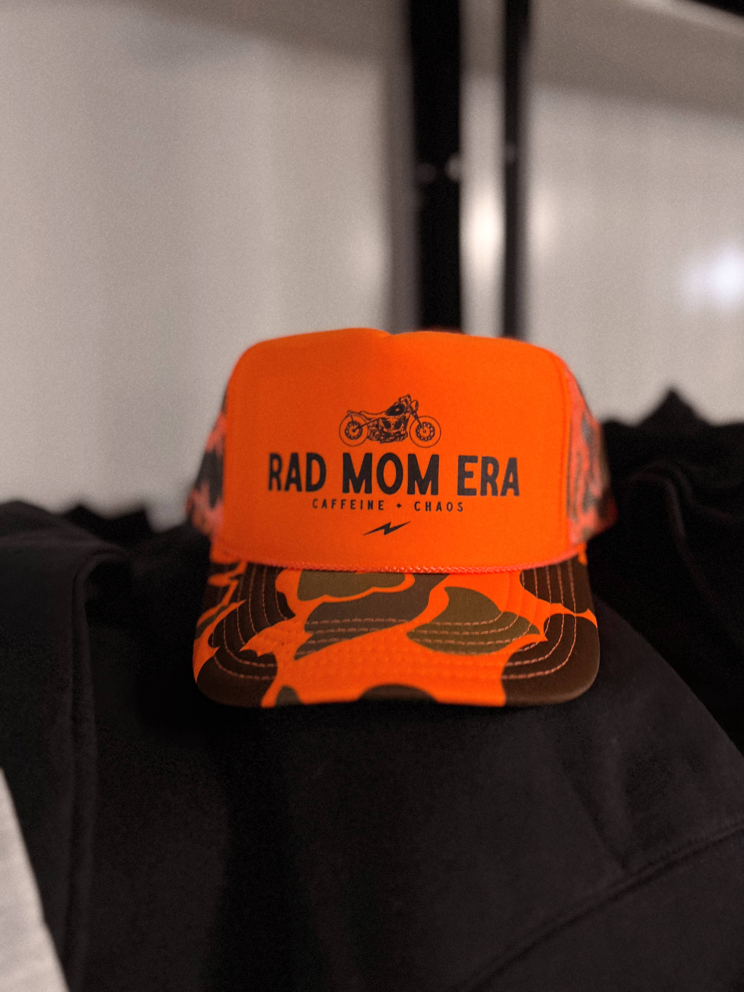 WE THE BABES - Rad Mom Era Trendy Trucker Hat - Neon Orange Camo